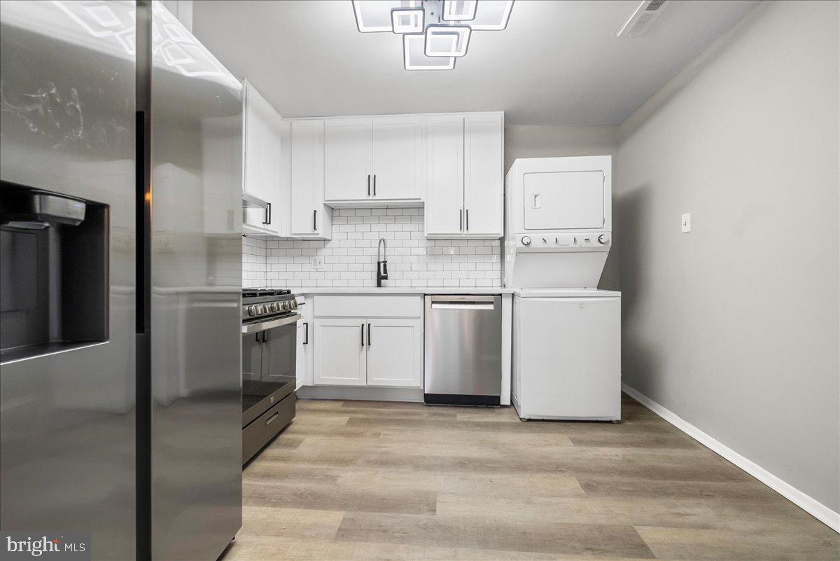 19030 Mills Choice Road, Unit 6 Gaithersburg, MD 20886 - Photo 8 of 21 a kitchen with white cabinets and white appliances