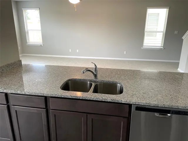 a kitchen with a sink and cabinets