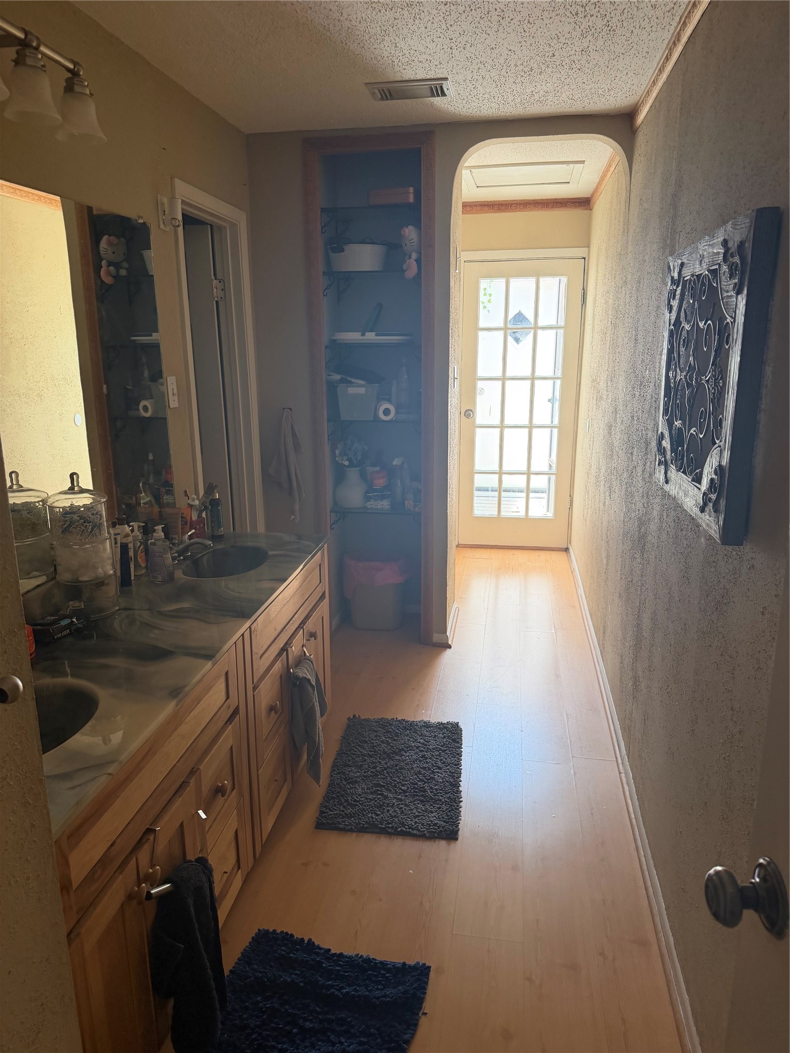 411 South Austin Street Webster, TX 77598 - Photo 9 of 13 a bathroom with a double vanity sink a mirror and a bathtub