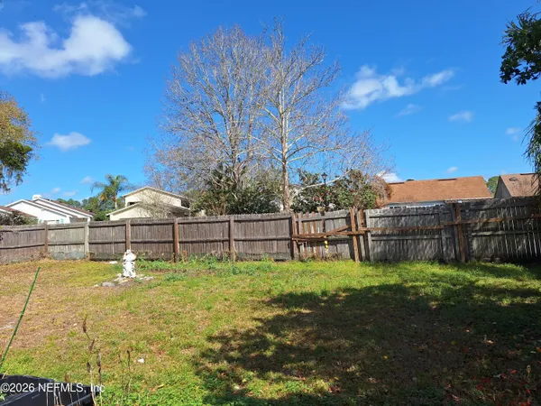 a swimming pool with outdoor seating and yard