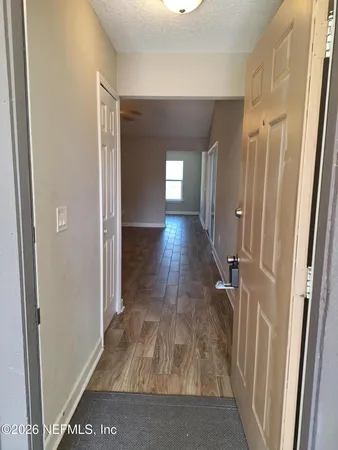 a view of hallway with wooden floor