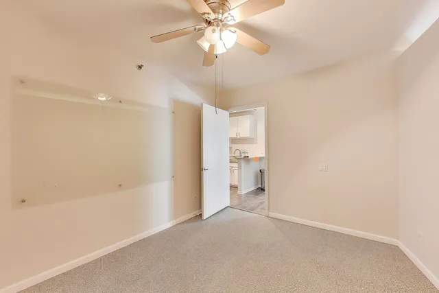 a view of a room with a ceiling fan and shower