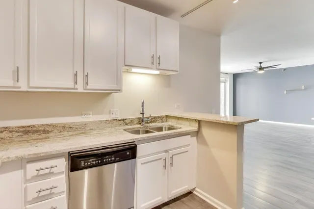 a kitchen with stainless steel appliances granite countertop a sink stove and cabinets