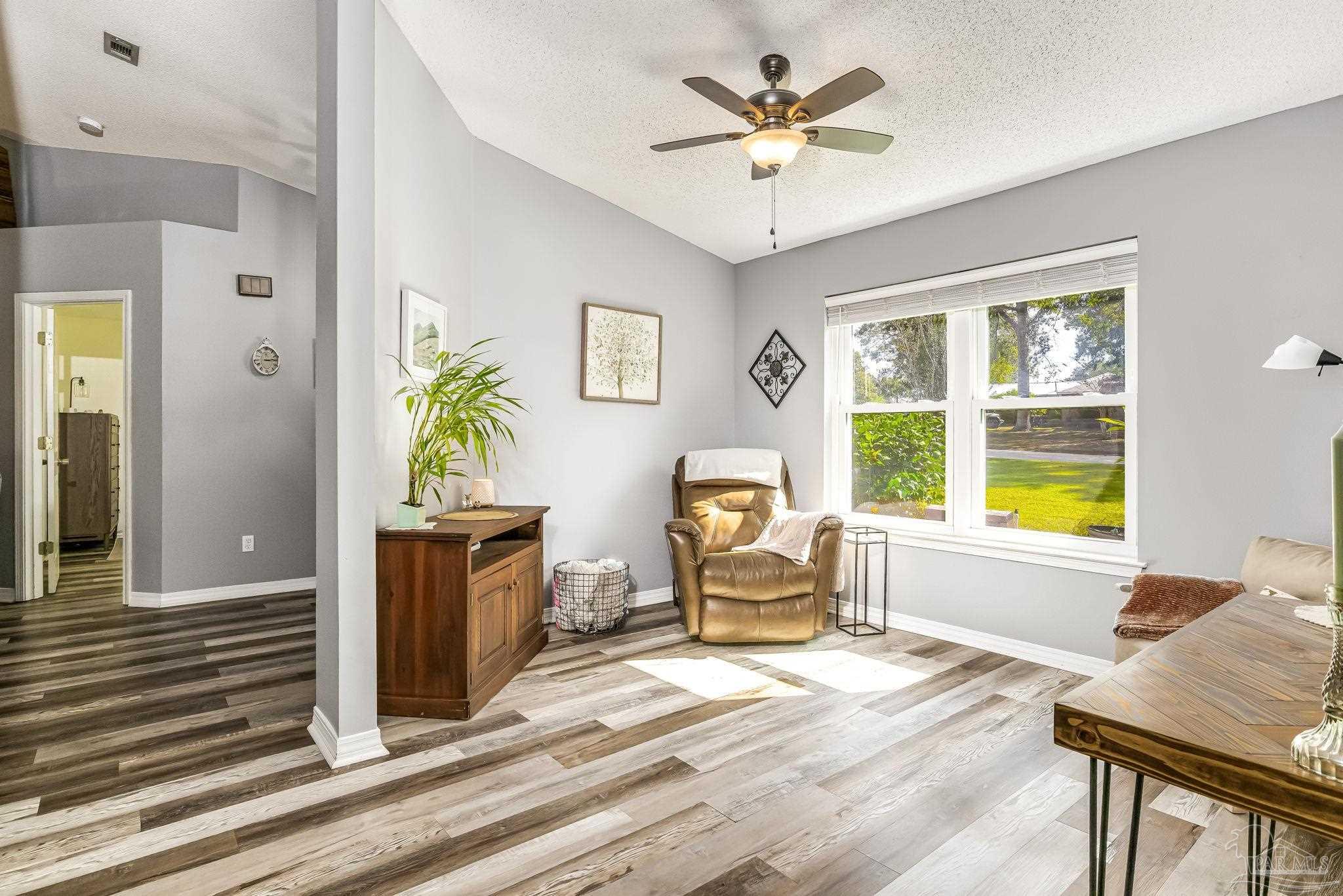 2000 Winners Circle Cantonment, FL 32533 - Photo 11 of 59 a living room with furniture and a large window