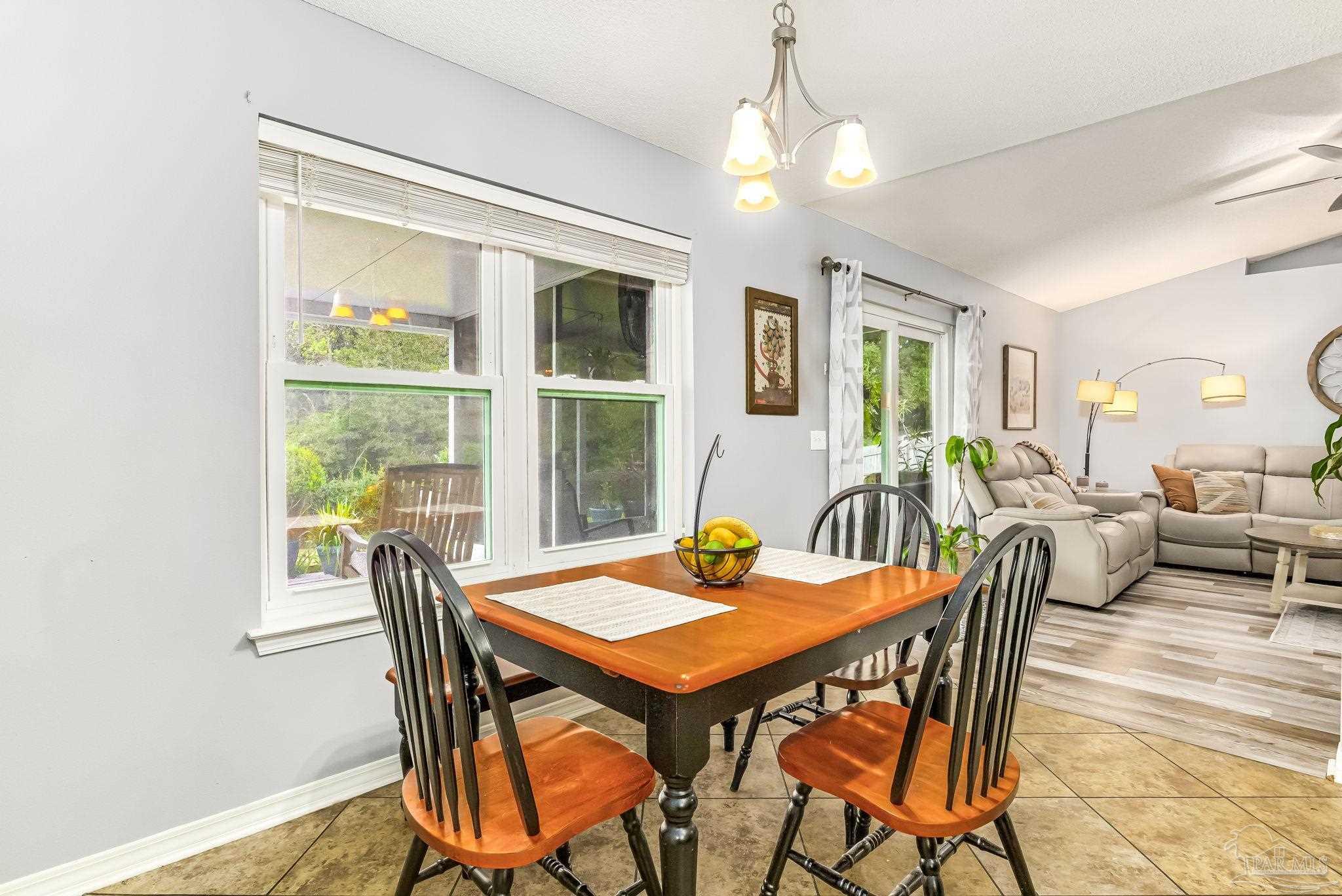 2000 Winners Circle Cantonment, FL 32533 - Photo 15 of 59 a view of a dining room with furniture window and wooden floor