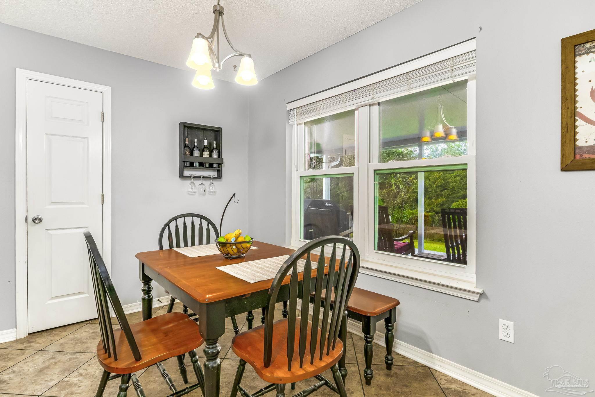 2000 Winners Circle Cantonment, FL 32533 - Photo 16 of 59 a view of a dining room with furniture window and outside view