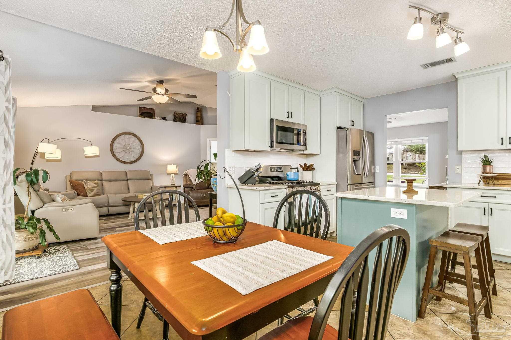 2000 Winners Circle Cantonment, FL 32533 - Photo 18 of 59 a view of a dining room with furniture and a chandelier