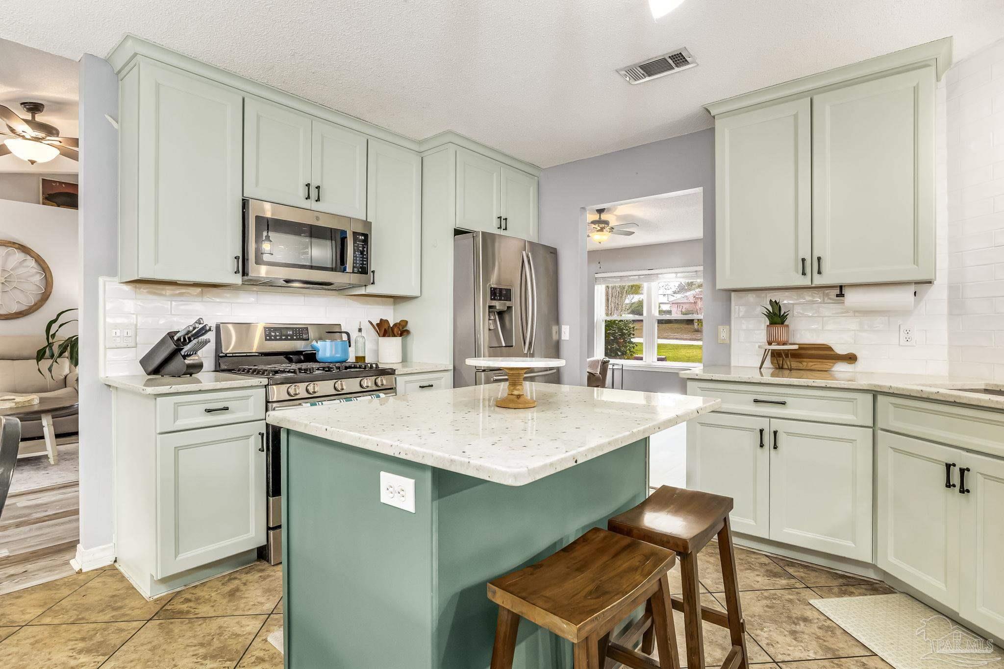 2000 Winners Circle Cantonment, FL 32533 - Photo 19 of 59 a kitchen with a stove a sink and a refrigerator