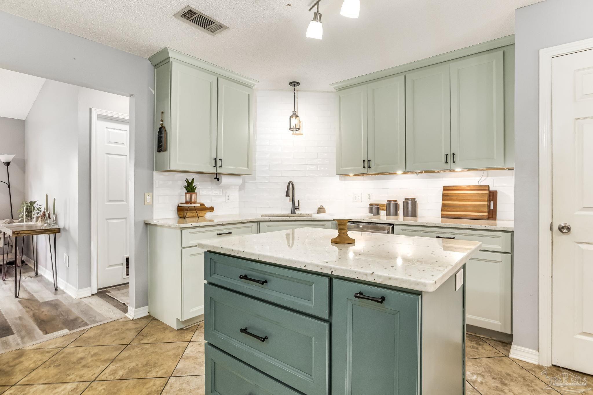 2000 Winners Circle Cantonment, FL 32533 - Photo 22 of 59 a kitchen with stainless steel appliances granite countertop a sink stove and cabinets