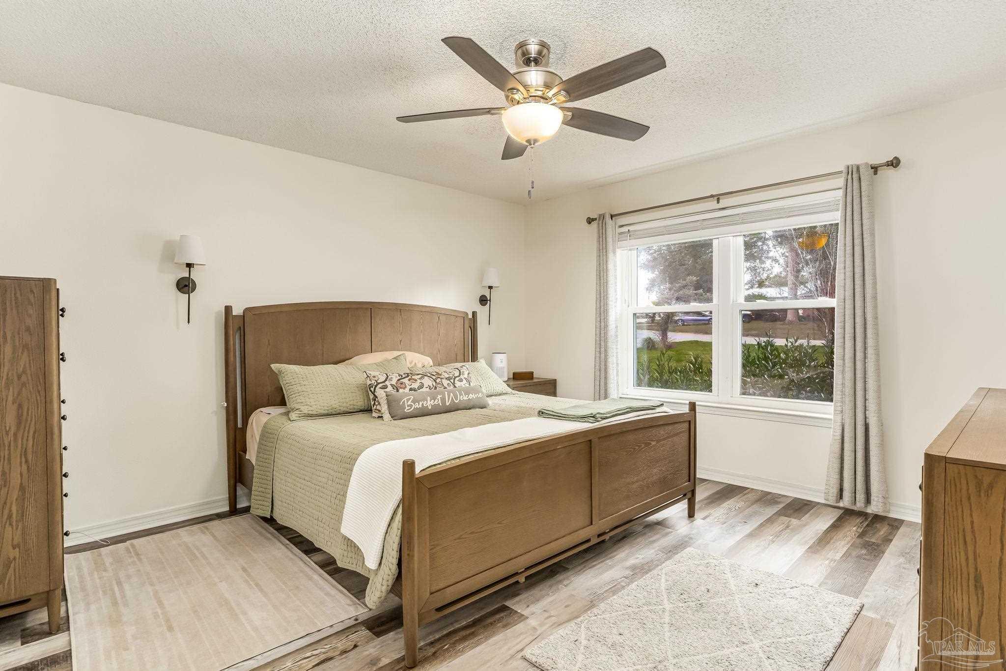 2000 Winners Circle Cantonment, FL 32533 - Photo 23 of 59 a bedroom with a large bed and a window