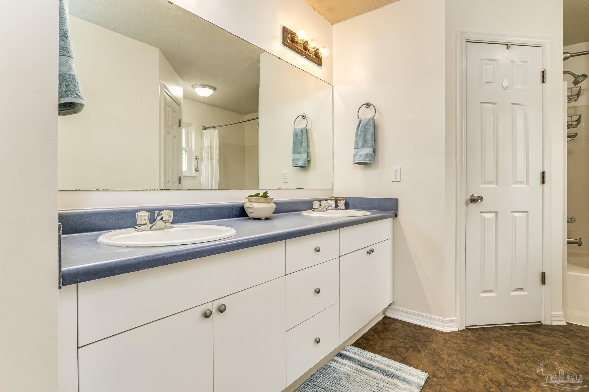 2000 Winners Circle Cantonment, FL 32533 - Photo 27 of 59 a bathroom with a double vanity sink and a mirror