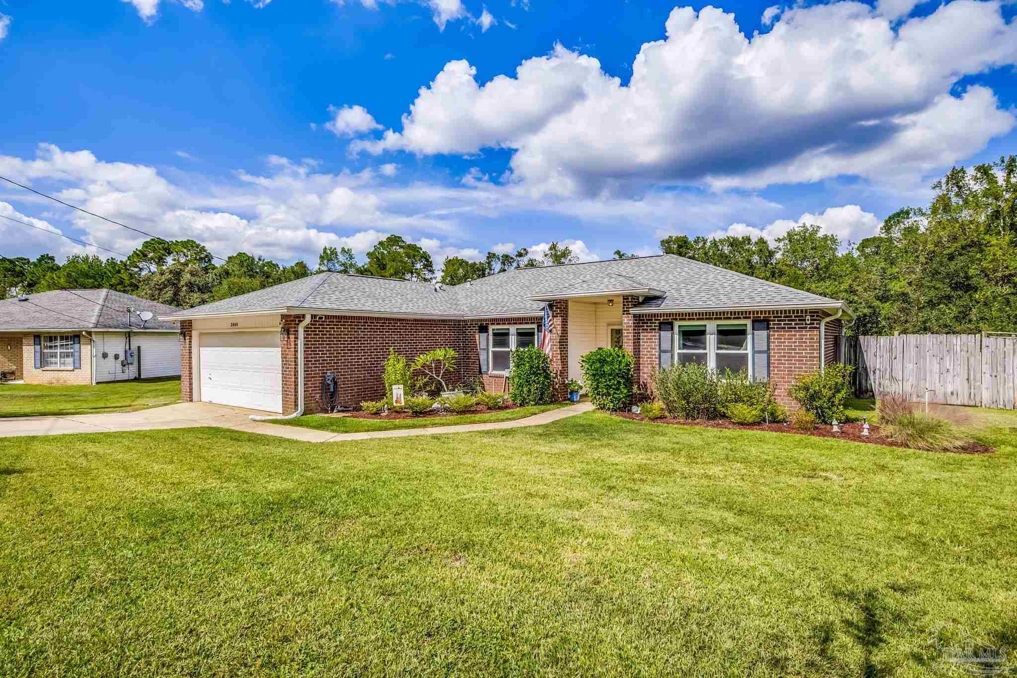 2000 Winners Circle Cantonment, FL 32533 - Photo 3 of 59 a view of a house with a yard and sitting area
