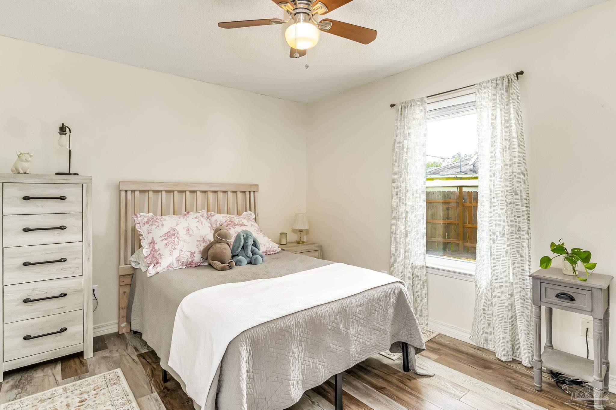 2000 Winners Circle Cantonment, FL 32533 - Photo 35 of 59 a bedroom with a bed and dresser