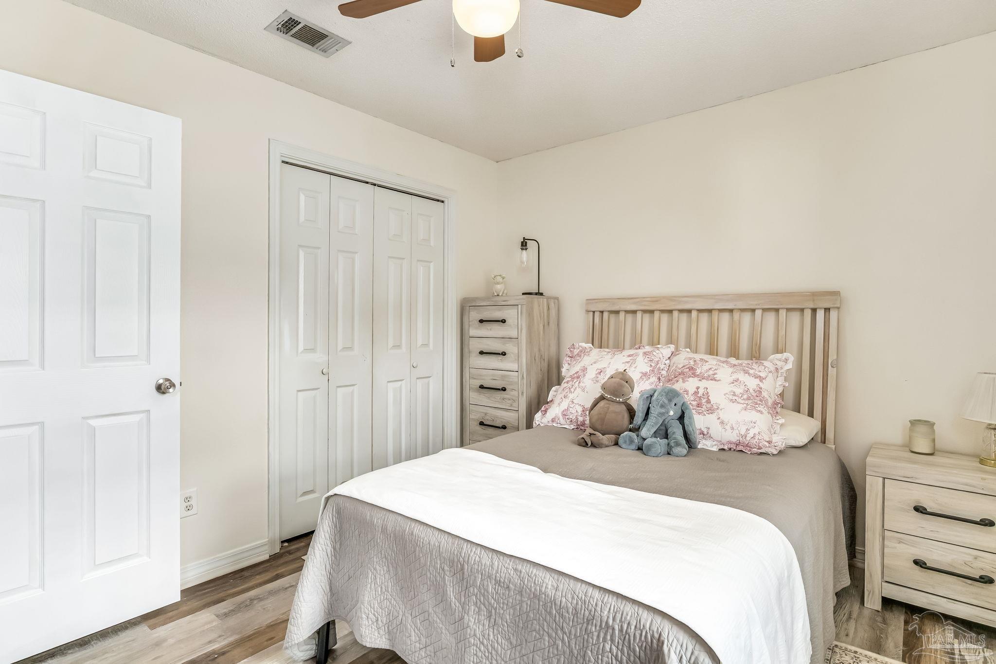 2000 Winners Circle Cantonment, FL 32533 - Photo 36 of 59 a bedroom with a bed and a chandelier