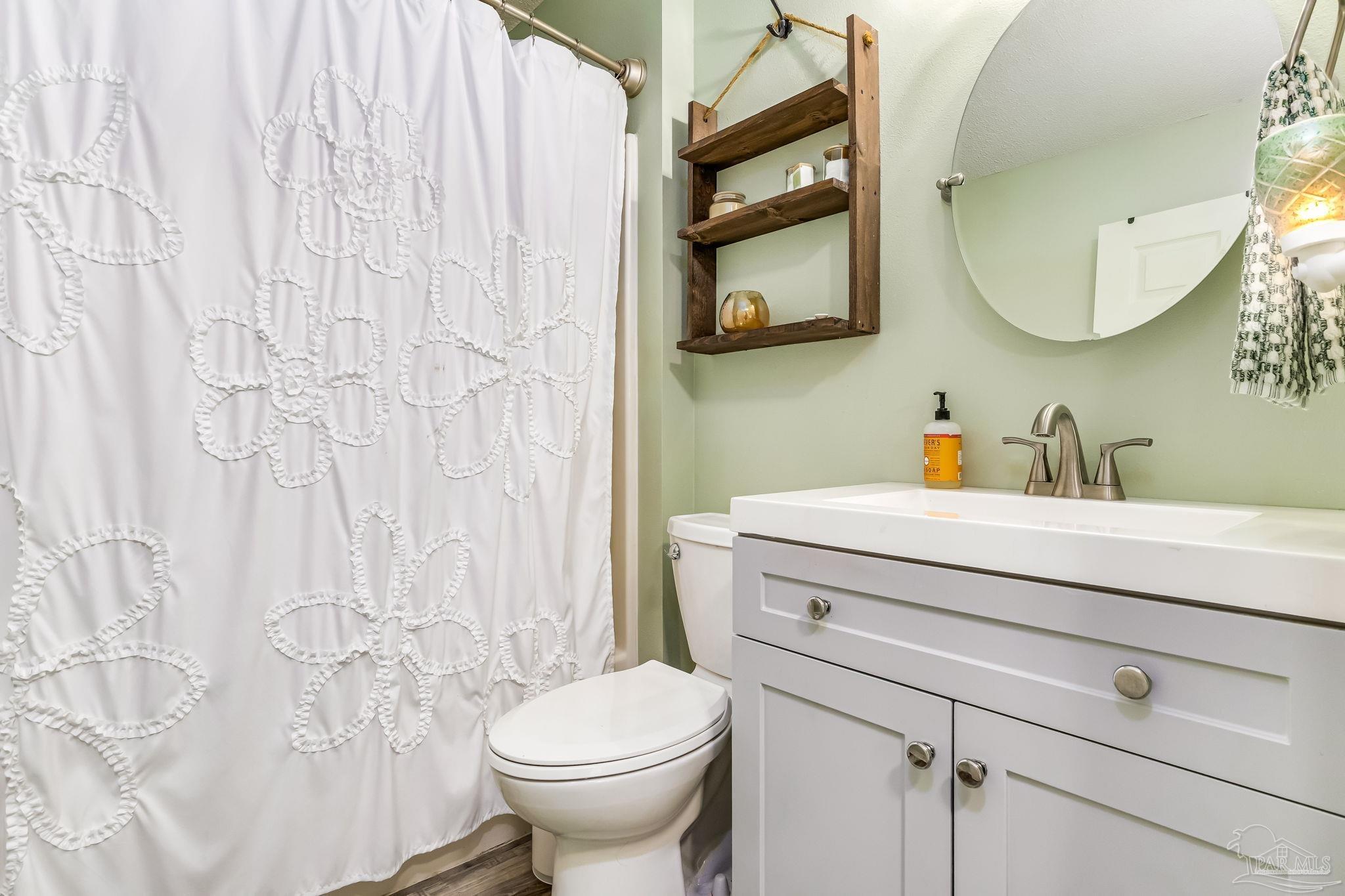 2000 Winners Circle Cantonment, FL 32533 - Photo 38 of 59 a bathroom with a sink toilet and mirror