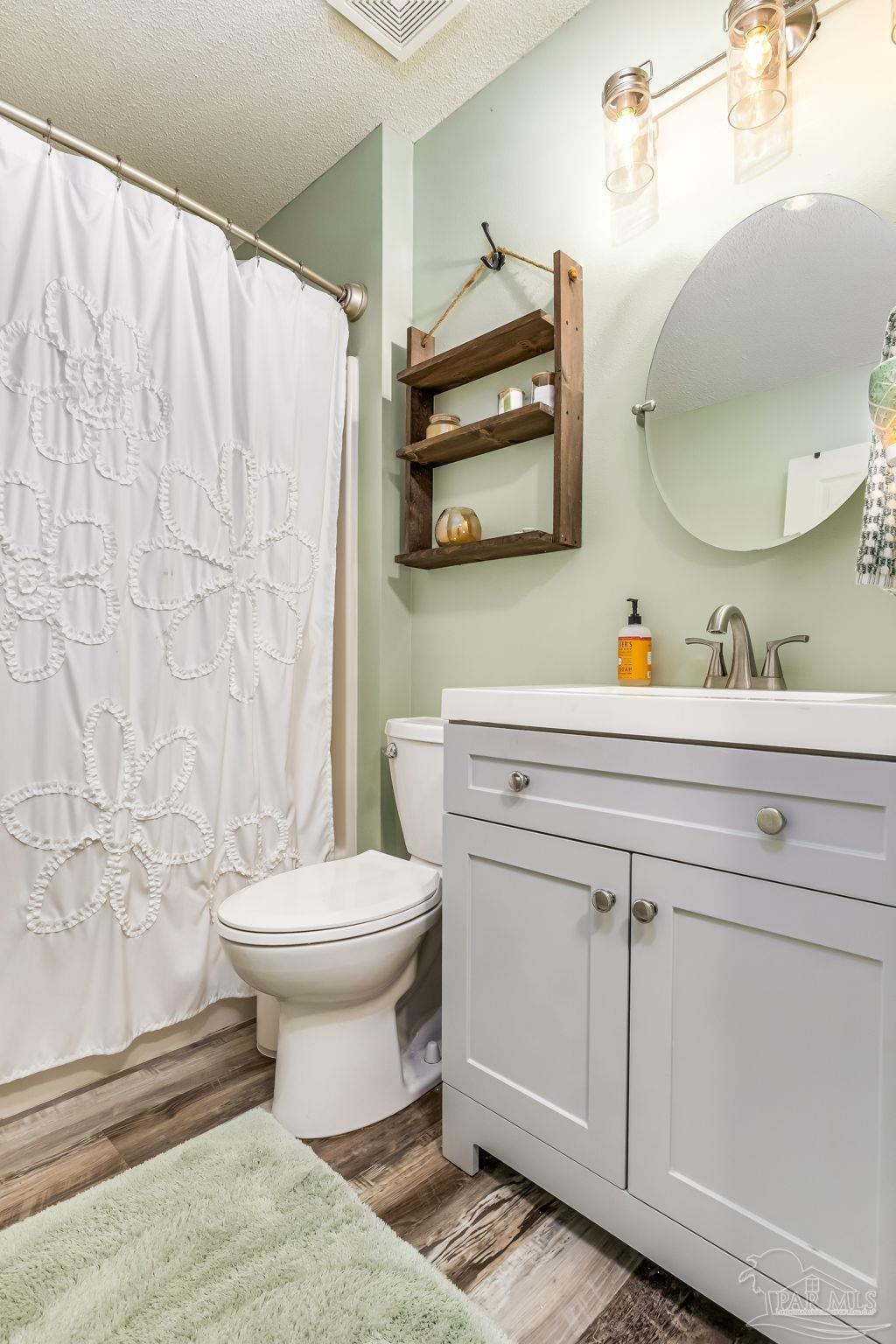 2000 Winners Circle Cantonment, FL 32533 - Photo 39 of 59 a bathroom with a toilet sink and mirror