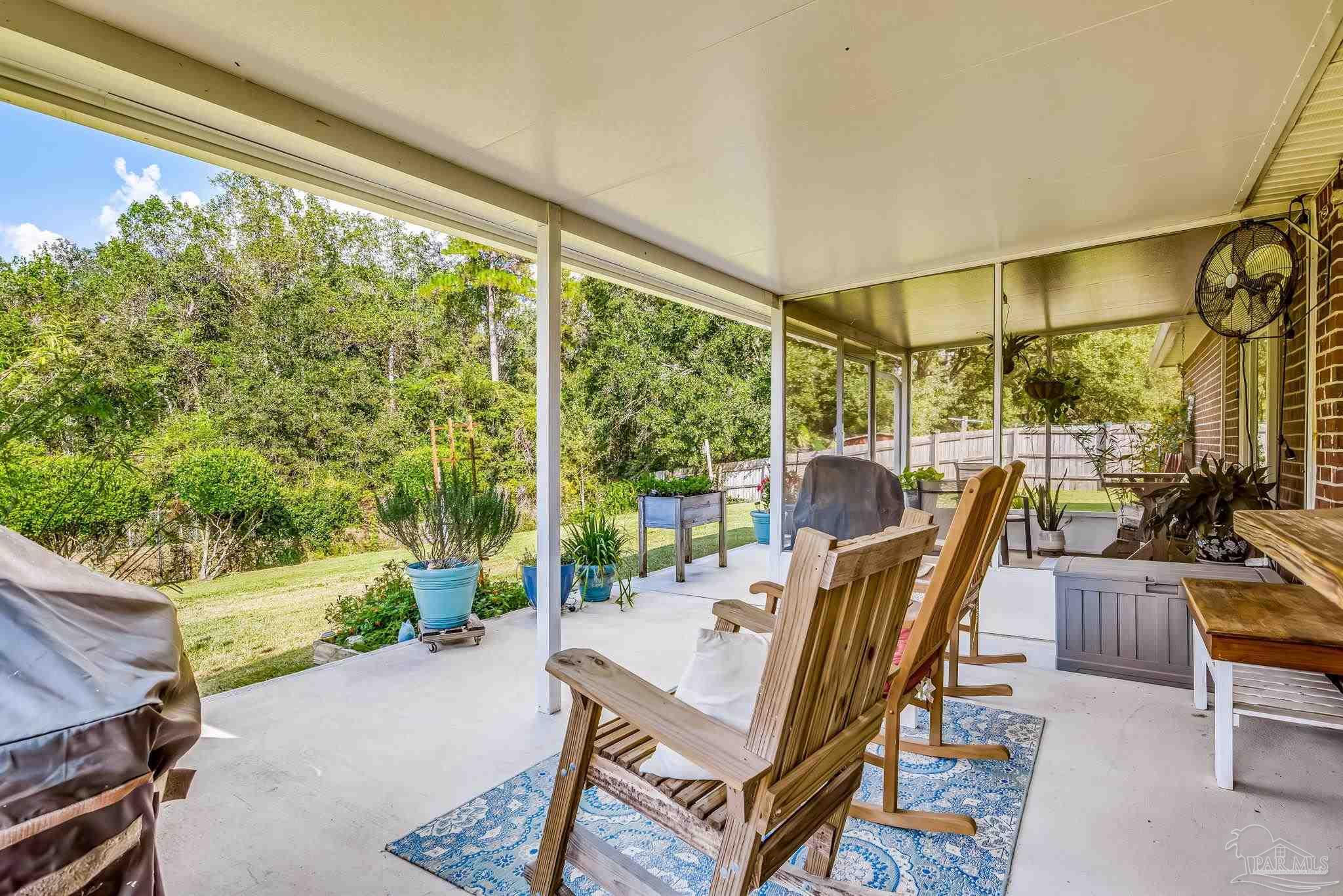 2000 Winners Circle Cantonment, FL 32533 - Photo 45 of 59 a dining room with furniture and a floor to ceiling window