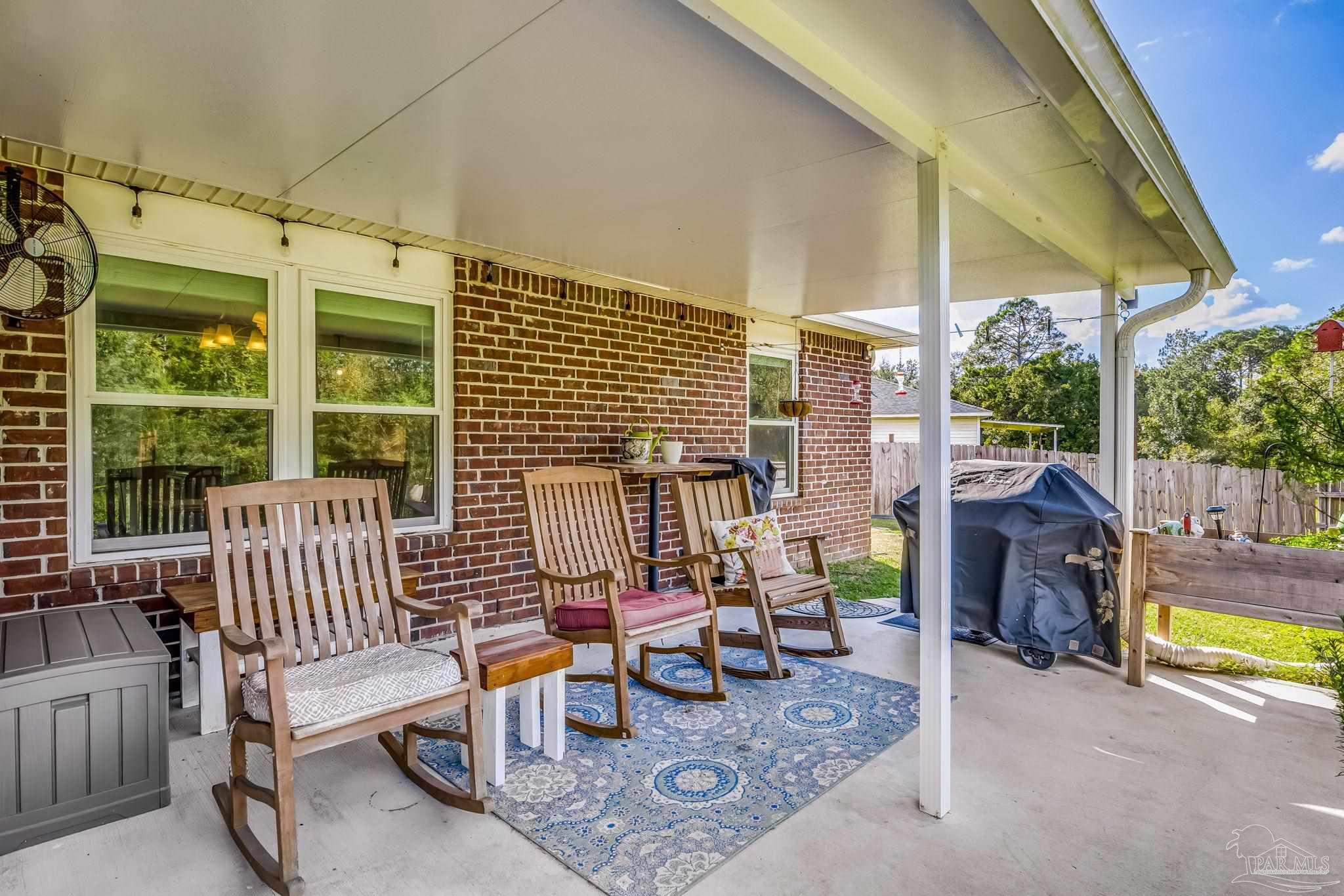 2000 Winners Circle Cantonment, FL 32533 - Photo 47 of 59 a view of a patio with a dining table and chairs