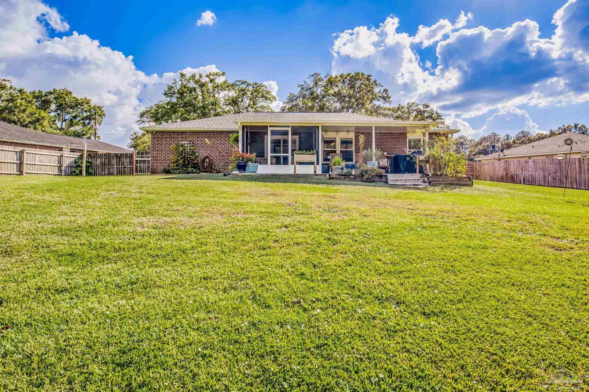 2000 Winners Circle Cantonment, FL 32533 - Photo 53 of 59 a front view of a house with a garden and swimming pool