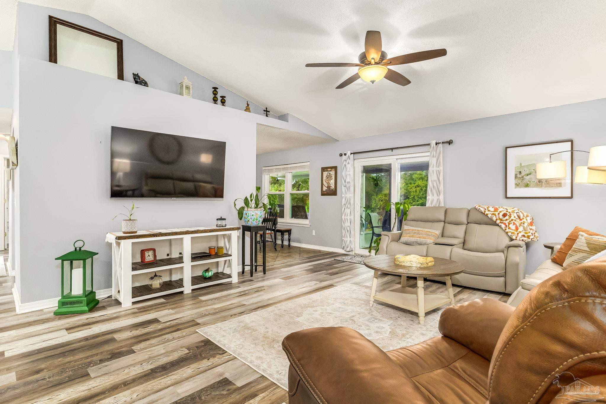 2000 Winners Circle Cantonment, FL 32533 - Photo 8 of 59 a living room with furniture and a flat screen tv