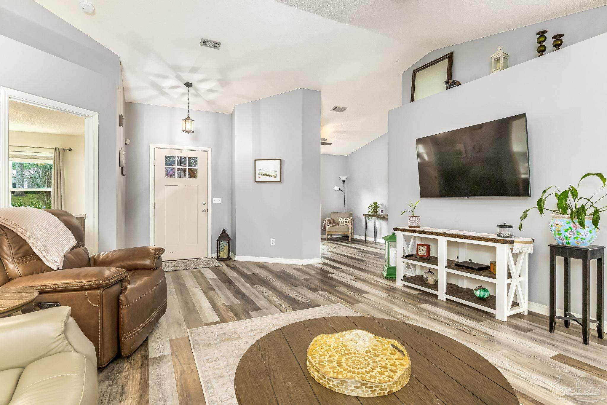 2000 Winners Circle Cantonment, FL 32533 - Photo 9 of 59 a living room with furniture and a flat screen tv