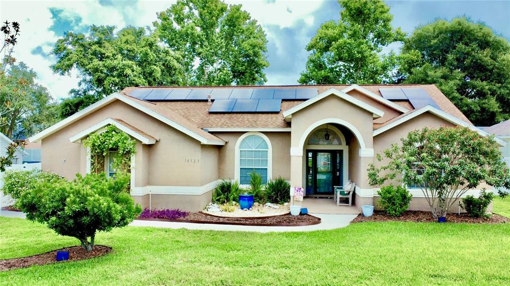 14723 Pine Cone Trail Clermont, FL 34711 - Photo 1 of 1 a front view of a house with a garden and plants