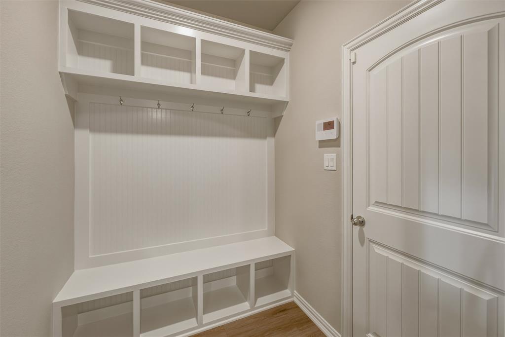 1232 Colca Drive Springtown, TX 76082 - Photo 17 of 23 Built-in mudroom bench with cubbies, overhead shelving, and coat hooks
