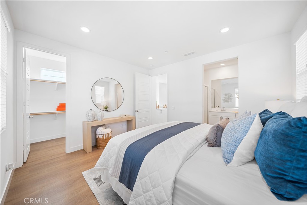 11016 Getaway Drive Rancho Cucamonga, CA 91730 - Photo 25 of 44 a bedroom with a large bed and a chandelier