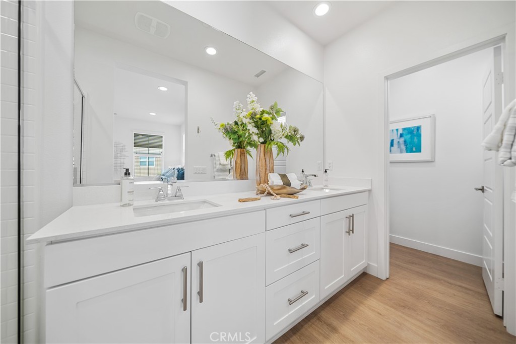 11016 Getaway Drive Rancho Cucamonga, CA 91730 - Photo 26 of 44 a bathroom with a double vanity sink and a mirror