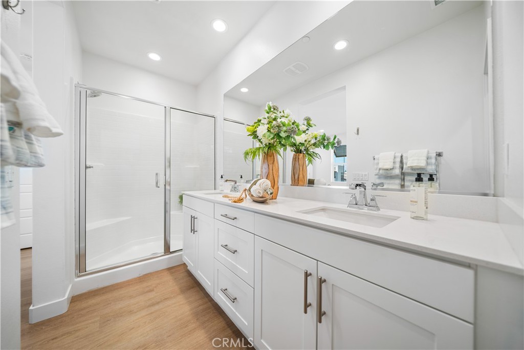 11016 Getaway Drive Rancho Cucamonga, CA 91730 - Photo 27 of 44 a bathroom with a double vanity sink mirror and shower
