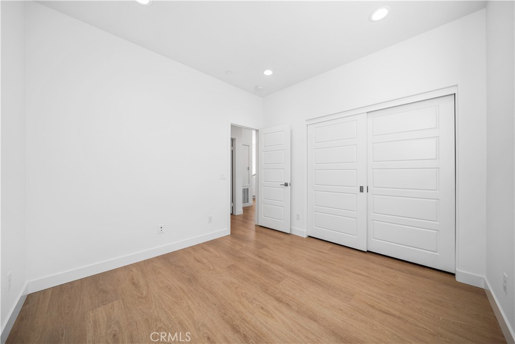 11016 Getaway Drive Rancho Cucamonga, CA 91730 - Photo 33 of 44 an empty room with wooden floor