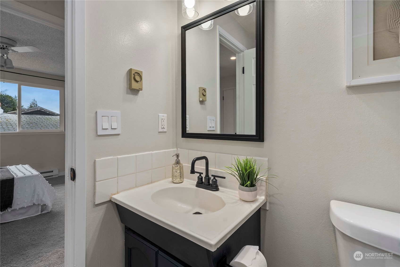 2004 North E Street Aberdeen, WA 98520 - Photo 17 of 38 a bathroom with a toilet sink and mirror
