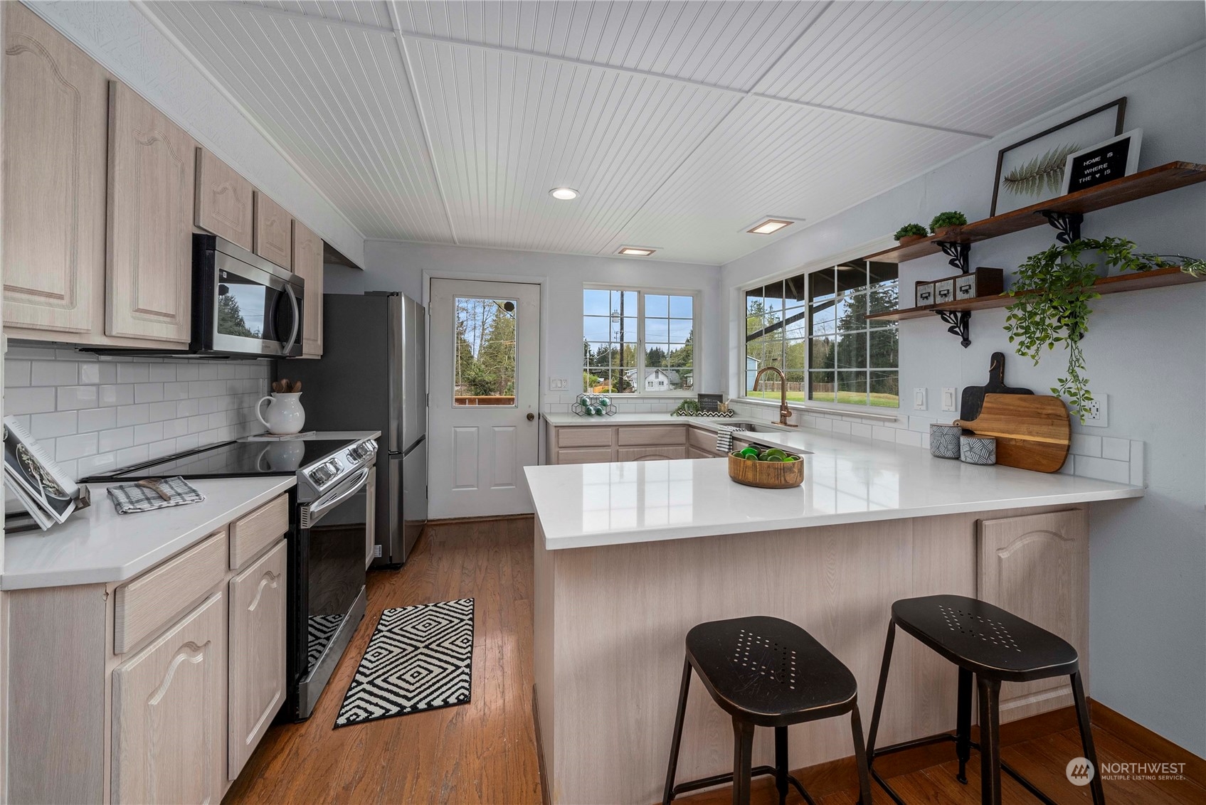 2004 North E Street Aberdeen, WA 98520 - Photo 8 of 38 a kitchen with stainless steel appliances granite countertop a sink a stove a refrigerator cabinets and chairs