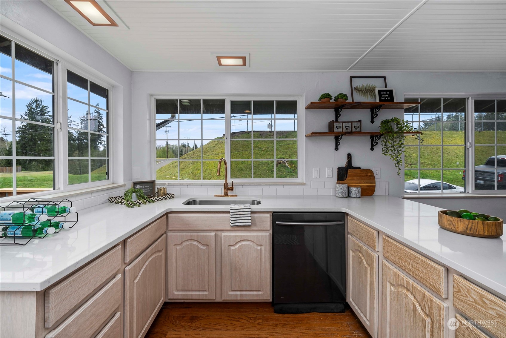 2004 North E Street Aberdeen, WA 98520 - Photo 9 of 38 a kitchen with a sink window and cabinets