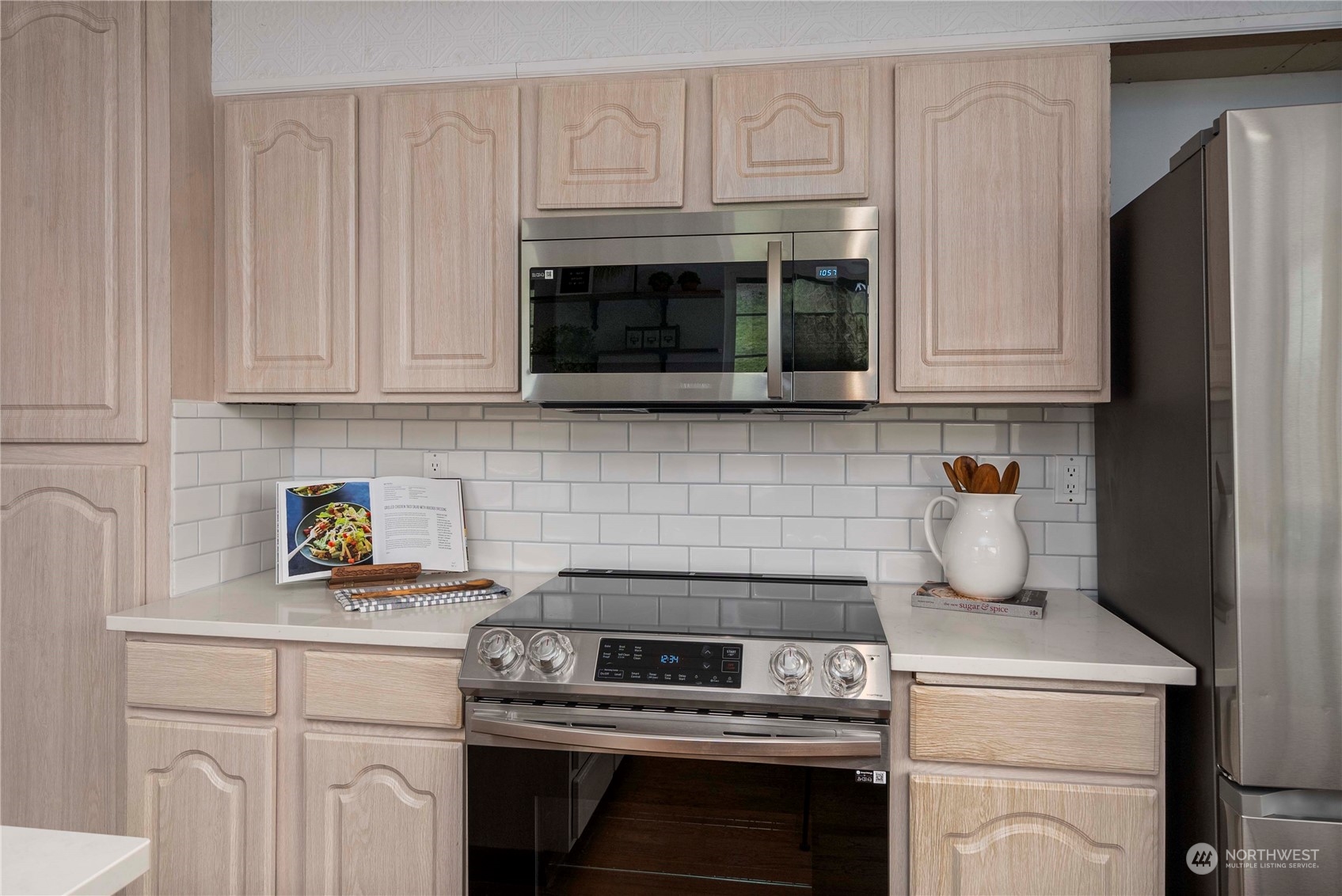 2004 North E Street Aberdeen, WA 98520 - Photo 10 of 38 a kitchen with granite countertop white cabinets and stainless steel appliances