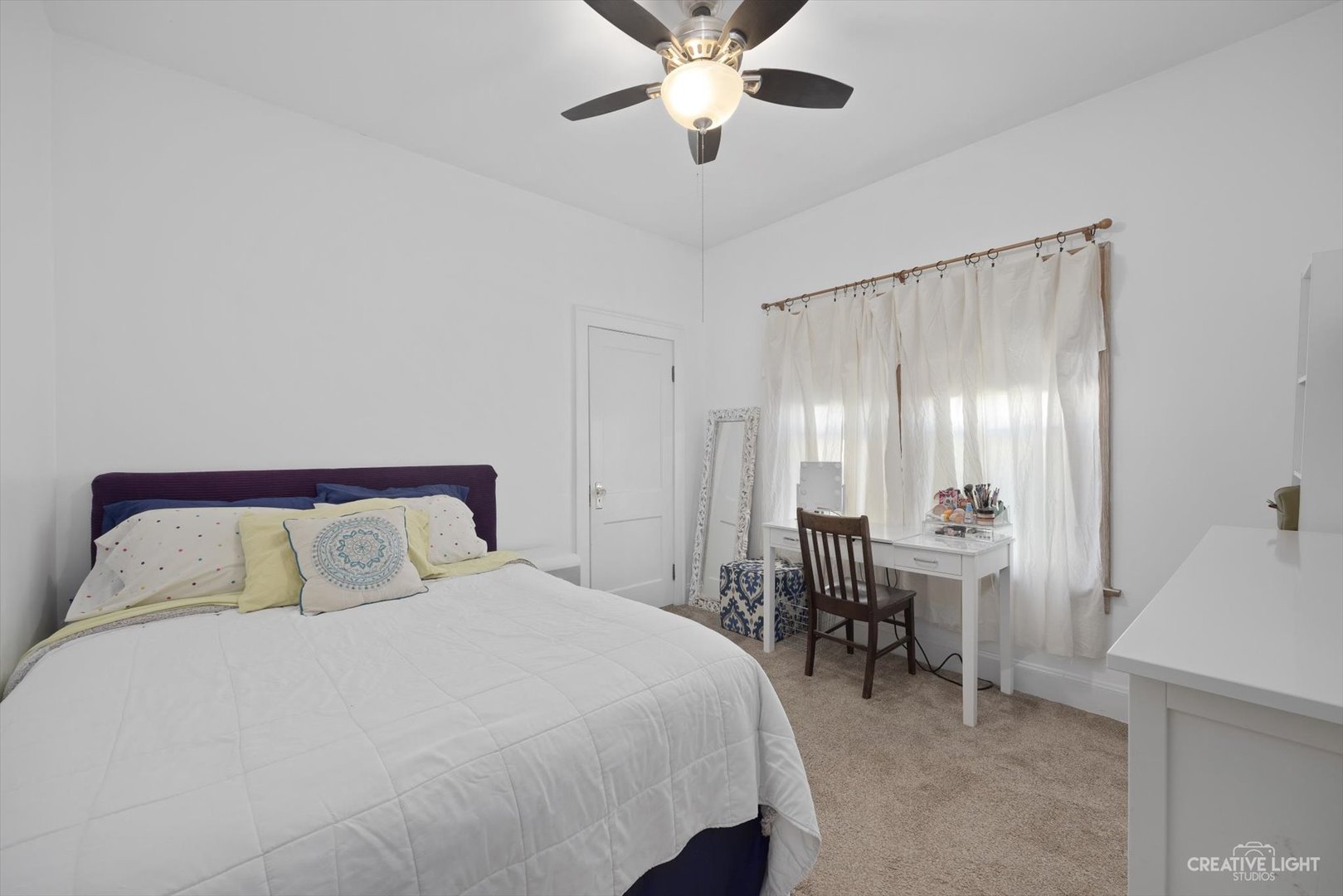 4534 Deyo Avenue Brookfield, IL 60513 - Photo 12 of 17 a bedroom with a bed and a chandelier