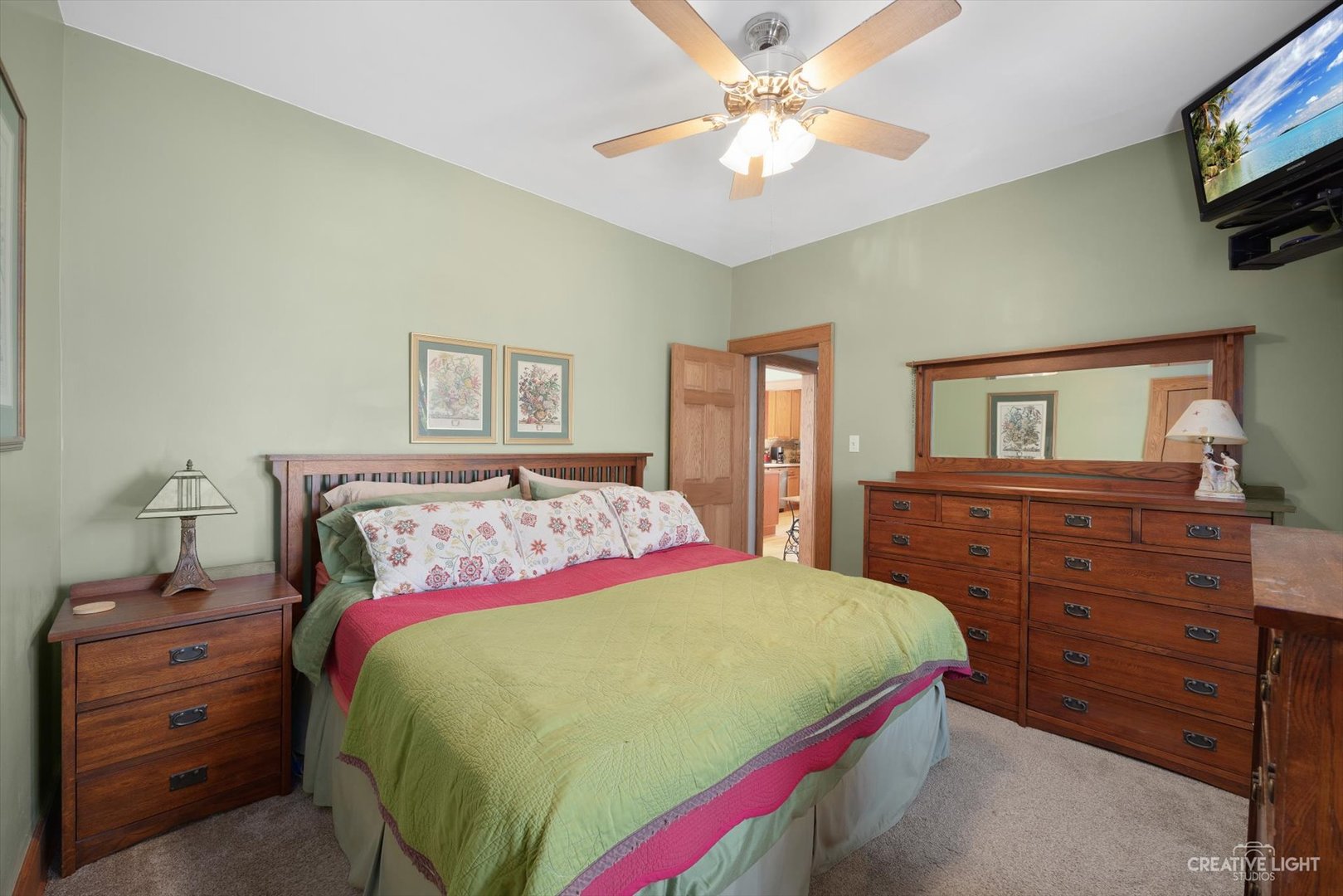 4534 Deyo Avenue Brookfield, IL 60513 - Photo 9 of 17 a bedroom with a bed and a tv on dresser