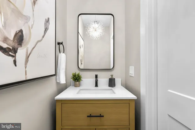 a open kitchen with stainless steel appliances granite countertop a stove a sink dishwasher a dining table and chairs with wooden floor