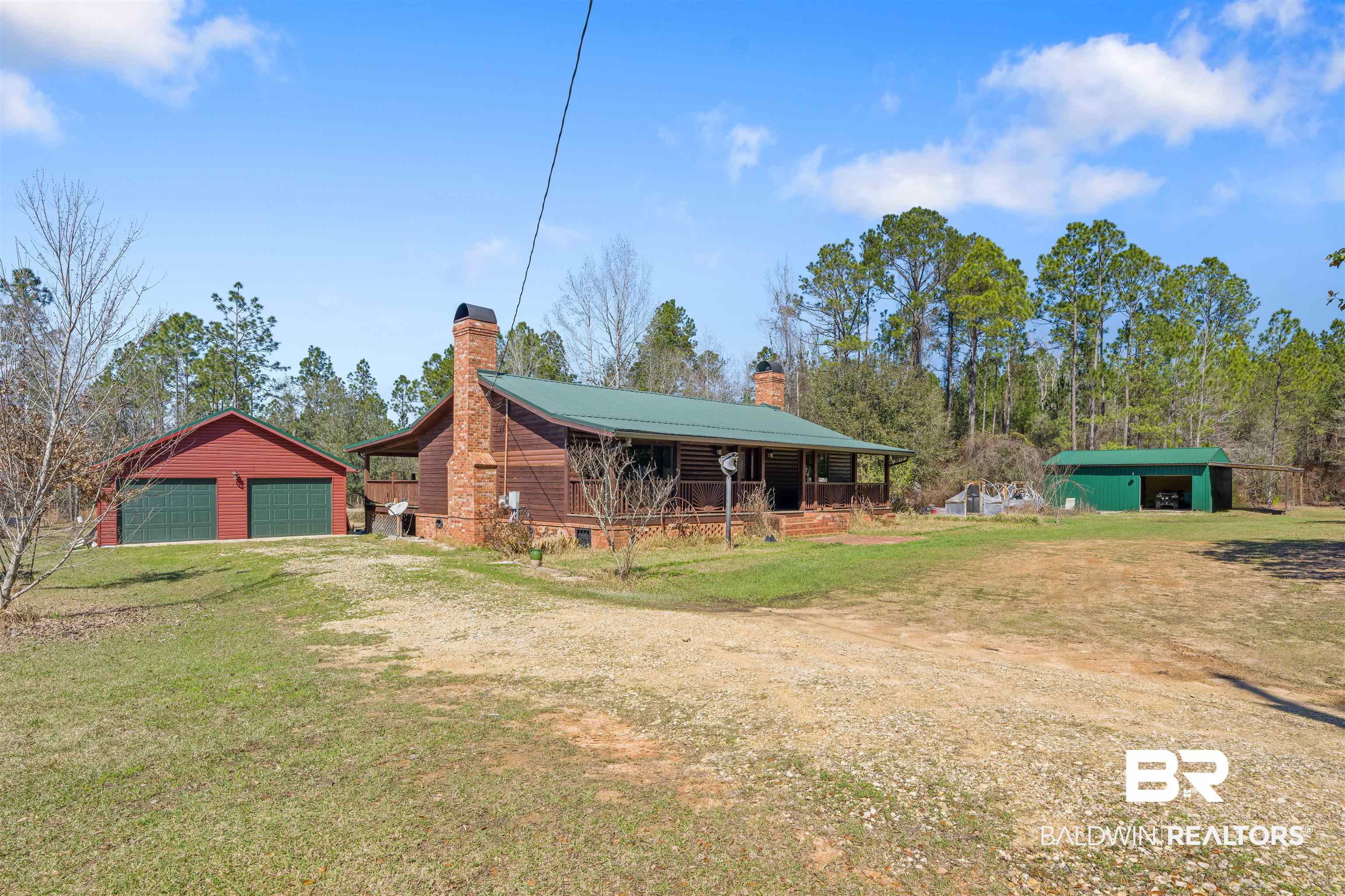 51699 Highway 31 Perdido, AL 36562 - Photo 3 of 30 Exterior space featuring an outdoor structure, driveway, and a detached garage