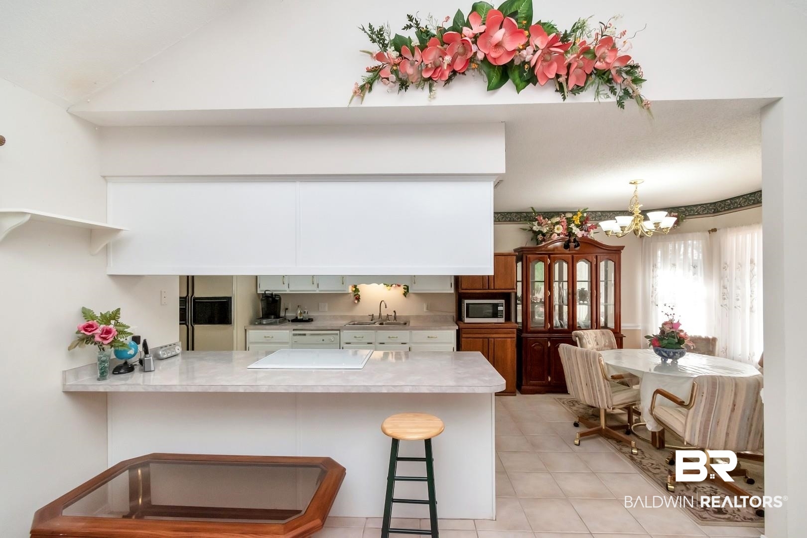8221 Woodbend Drive Semmes, AL 36575 - Photo 13 of 35 Kitchen with kitchen peninsula, a notable chandelier, sink, and a breakfast bar area