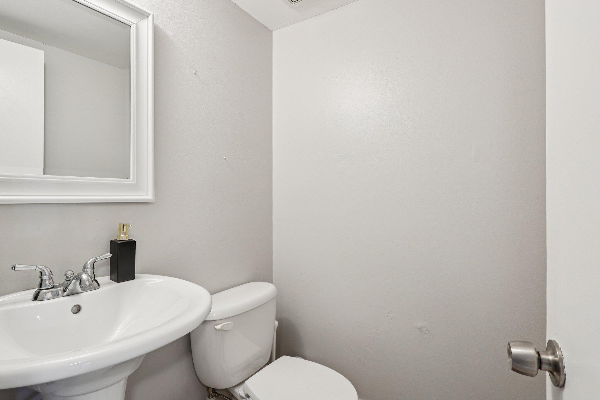6500 Cypress Road, Unit 508 Plantation, FL 33317 - Photo 12 of 32 a bathroom with a toilet sink and mirror