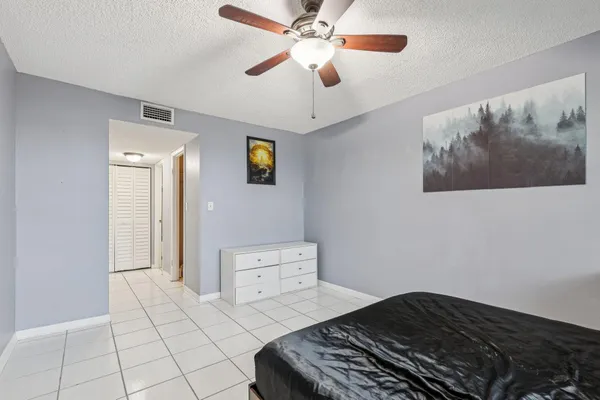 a bedroom with a bed and a painting on the wall