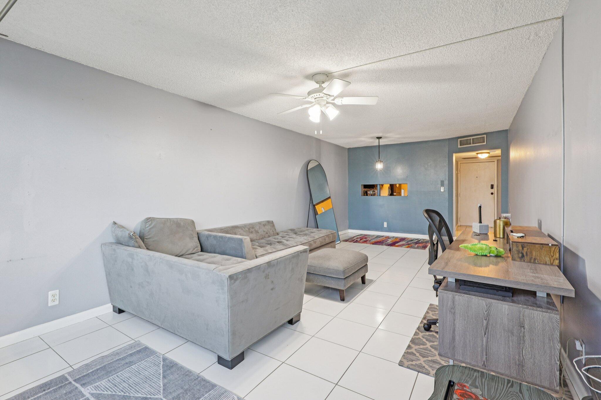 6500 Cypress Road, Unit 508 Plantation, FL 33317 - Photo 2 of 32 a living room with furniture and a chandelier