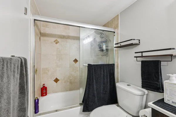 a bathroom with a toilet and a shower