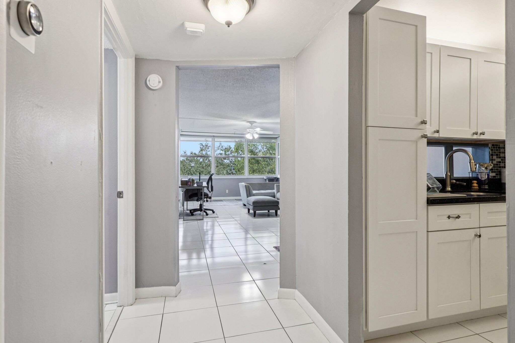 6500 Cypress Road, Unit 508 Plantation, FL 33317 - Photo 10 of 32 a kitchen with white cabinets and outdoor space