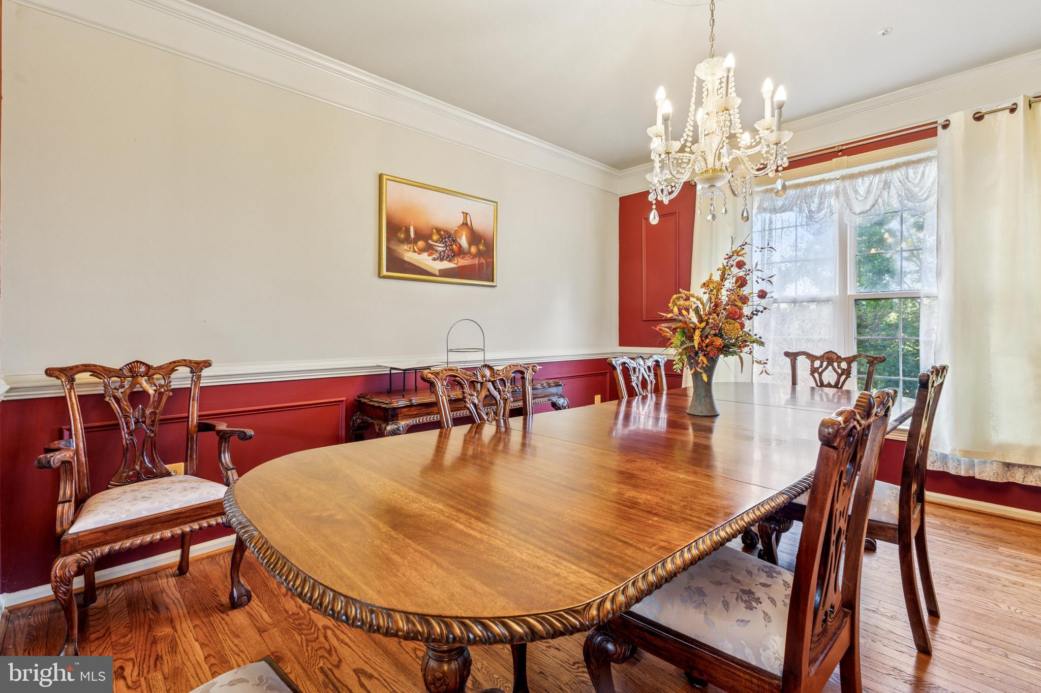 3401 Kidder Road Clinton, MD 20735 - Photo 6 of 45 a dining room with furniture a chandelier and wooden floor