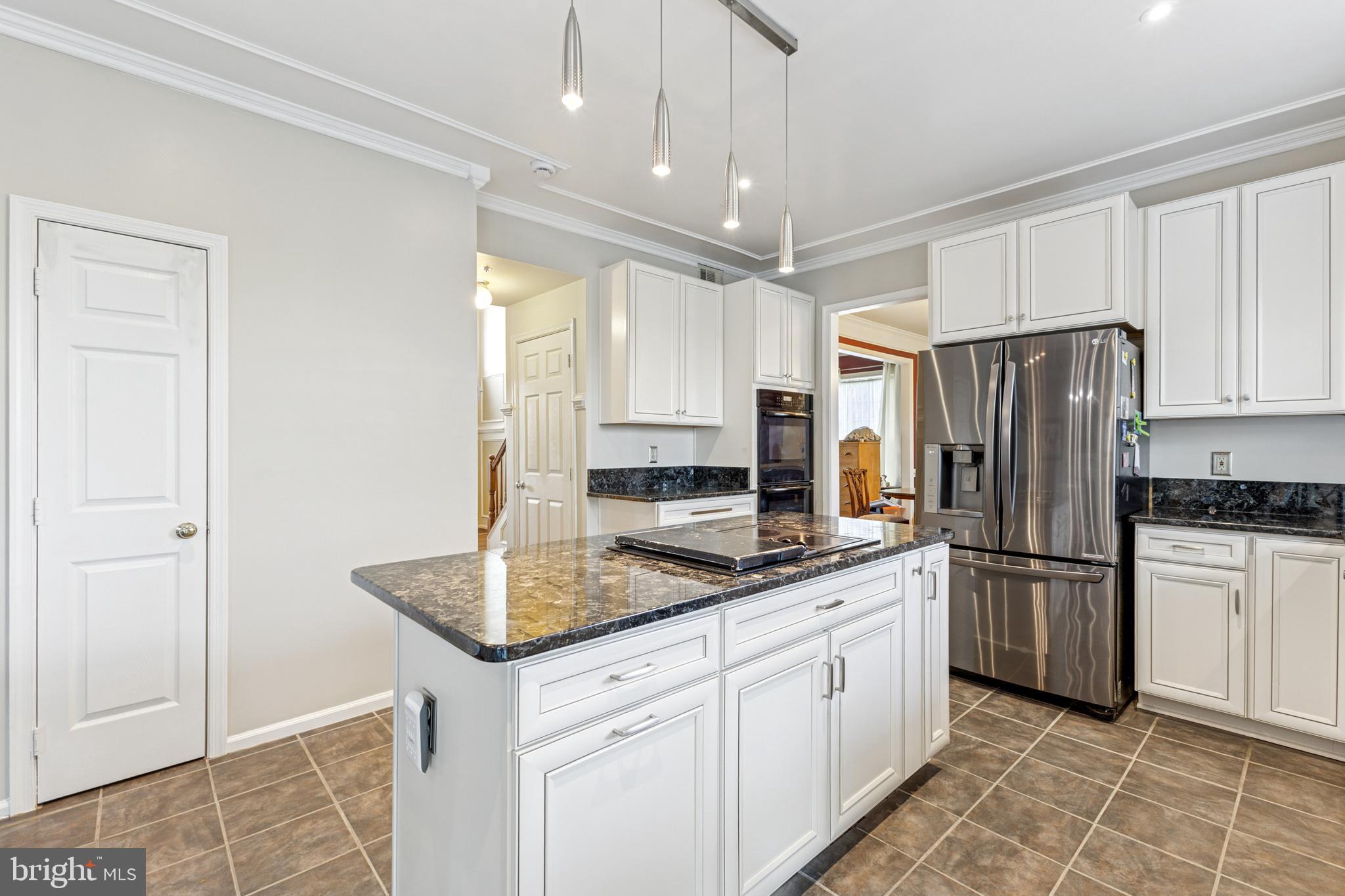 3401 Kidder Road Clinton, MD 20735 - Photo 10 of 45 a kitchen with stainless steel appliances granite countertop a refrigerator a sink and white cabinets