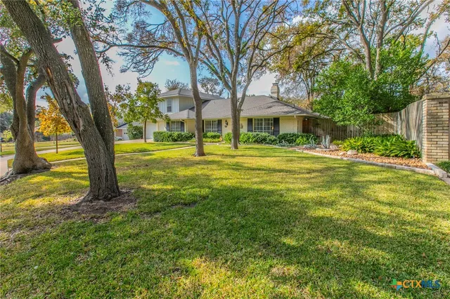 a view of a trees in front of a house