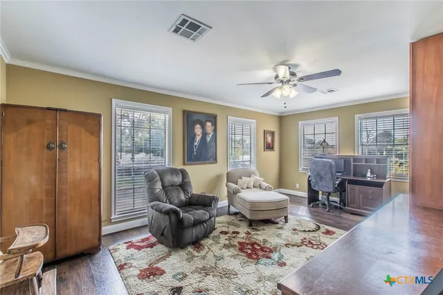 a living room with furniture and wooden floor