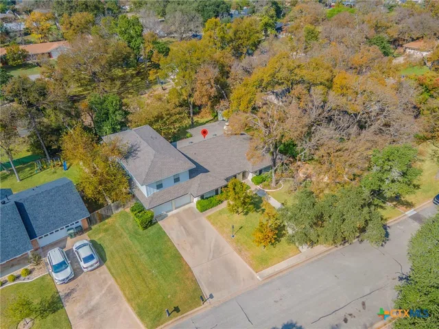 an aerial view of a house with a yard